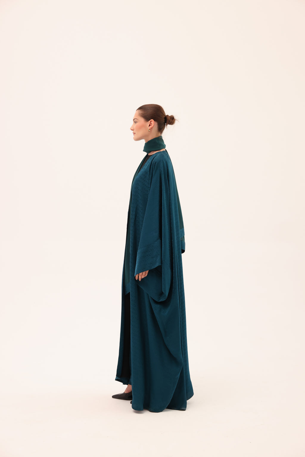 Opposite side view of the LUCE luxury turquoise silk abaya by Tre Sorelle