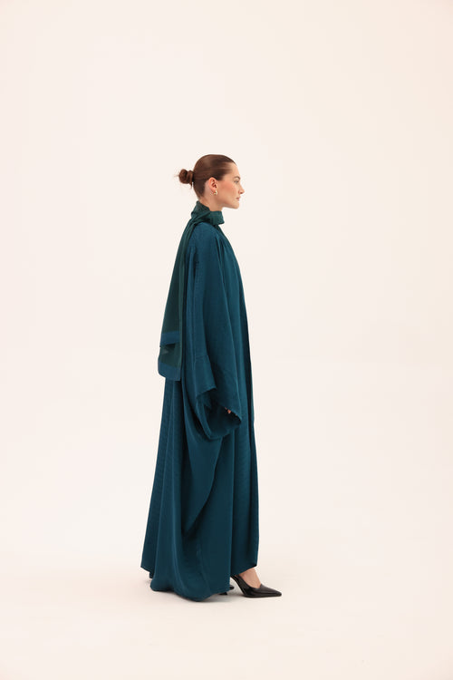 Side view of the LUCE luxury turquoise silk abaya by Tre Sorelle.