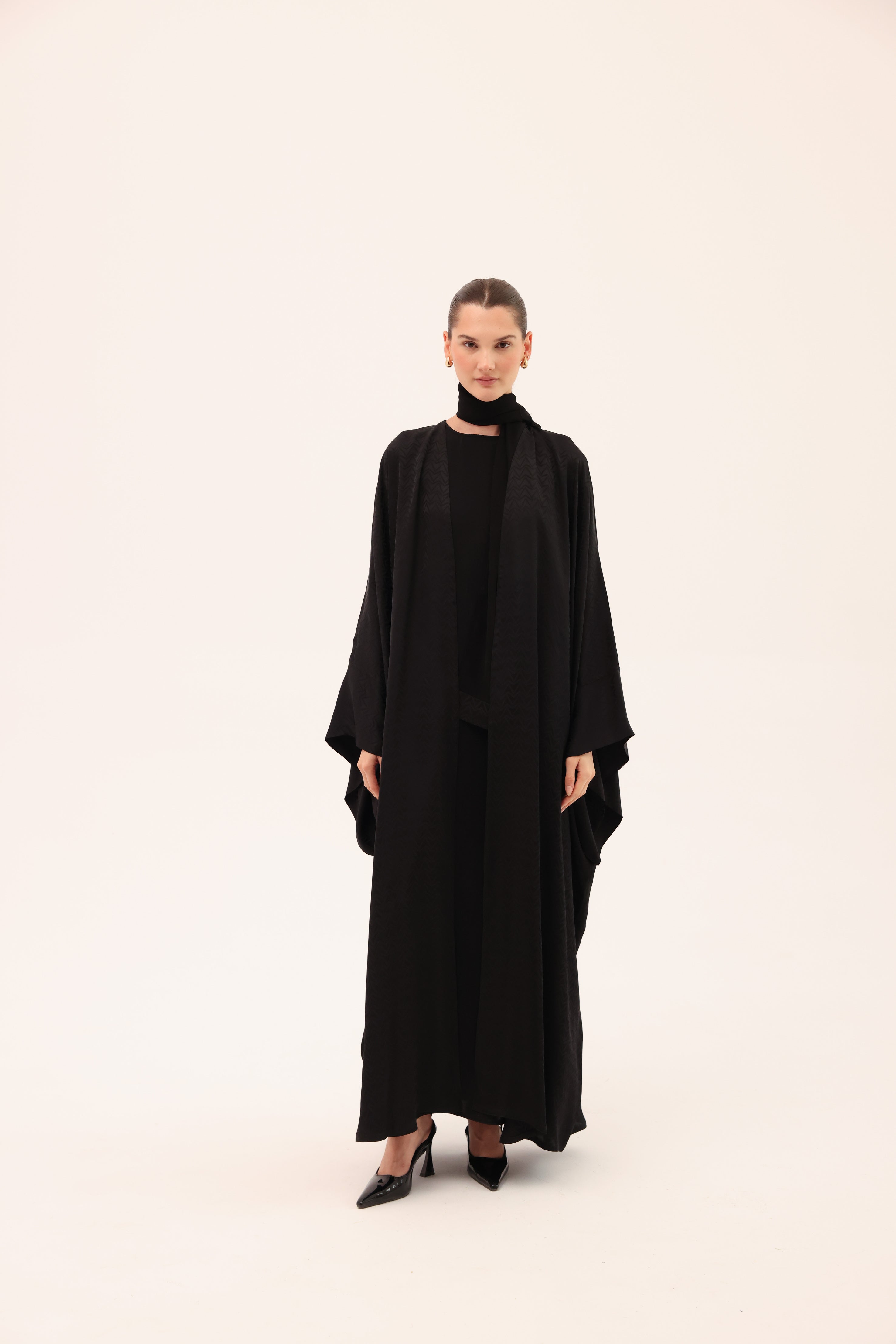 Model wearing the ARIA luxury black silk abaya by Tre Sorelle crafted from Signature Sorelle Silk™, front view.