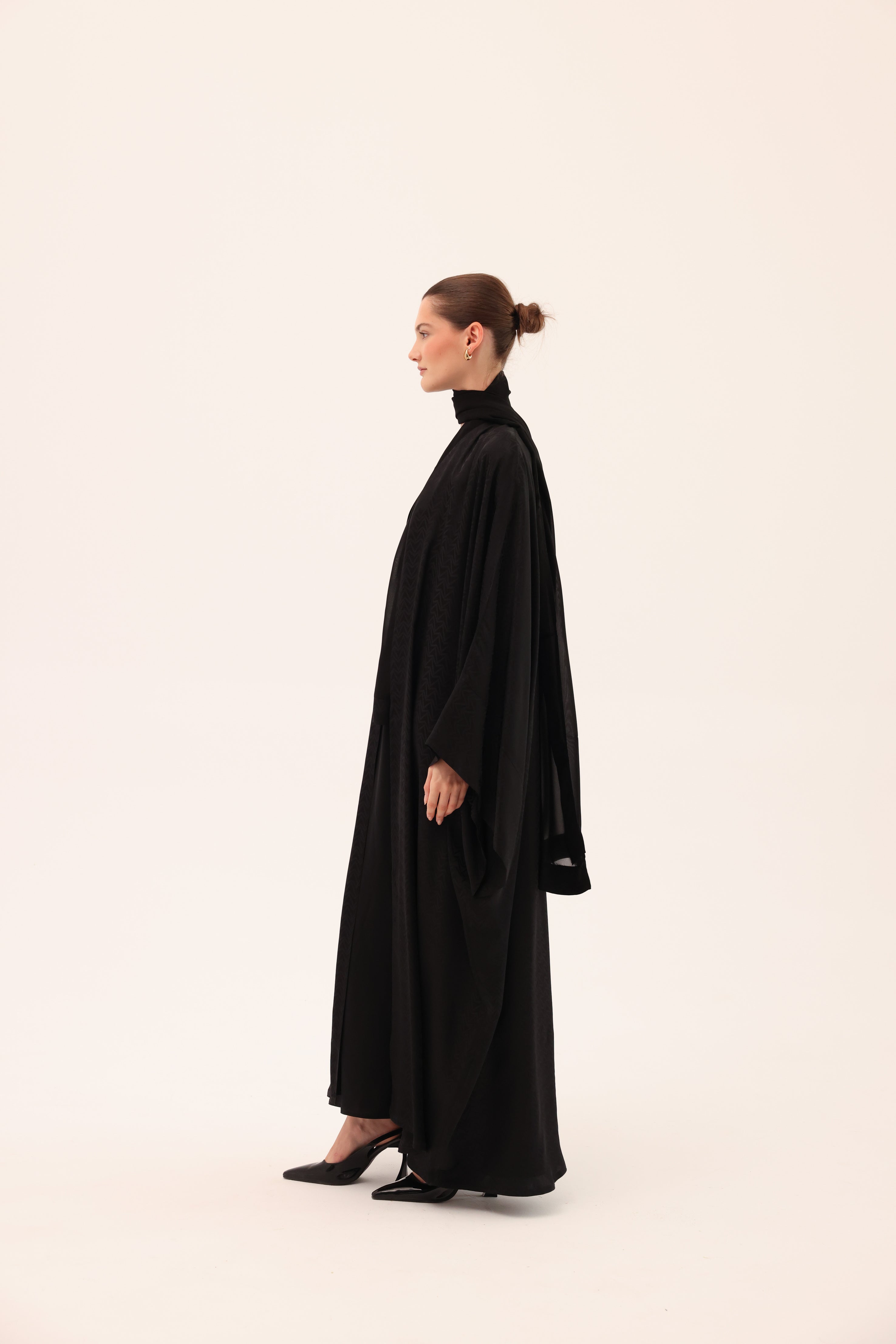 Side view of the ARIA luxury black silk abaya by Tre Sorelle.
