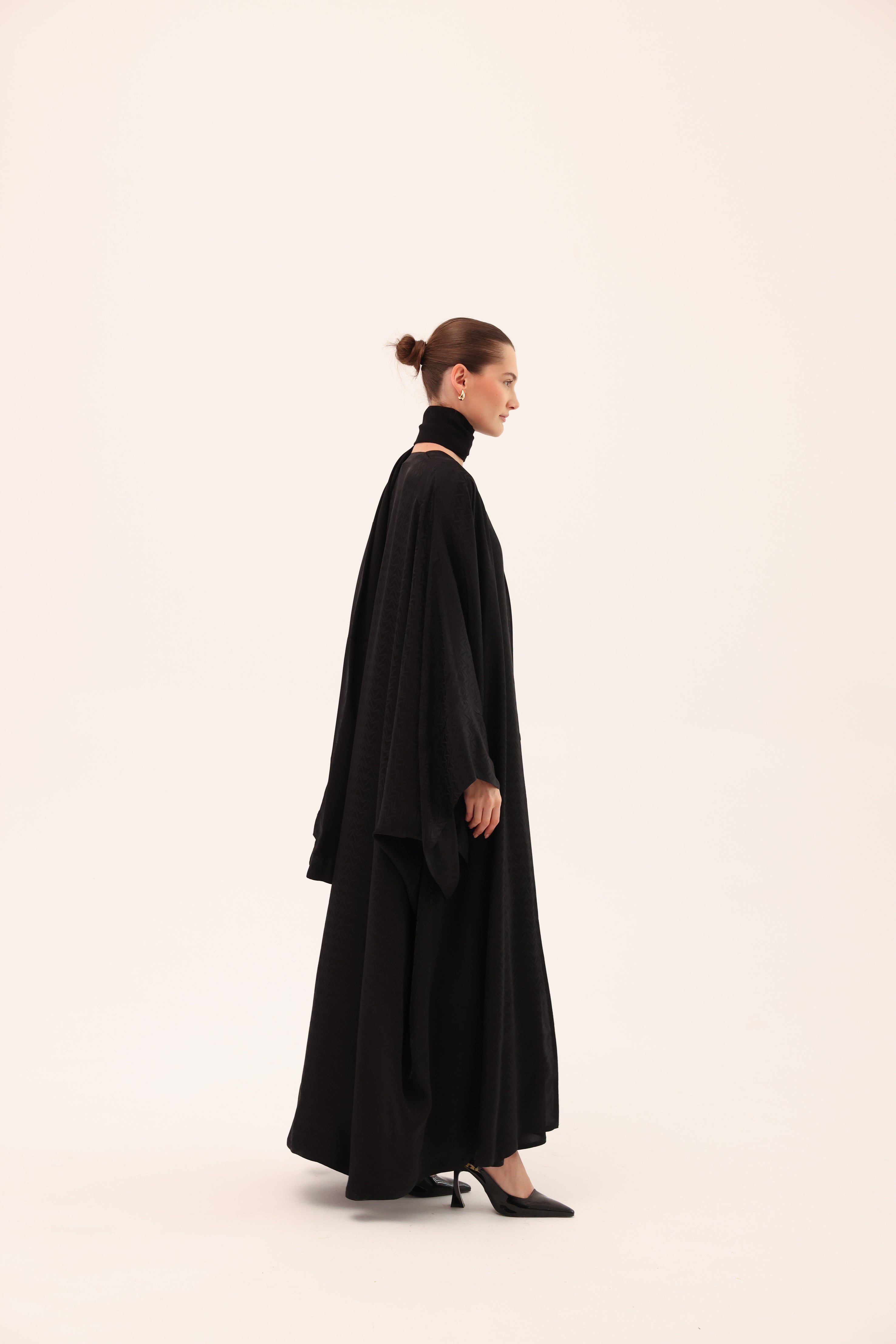 Opposite side view of the ARIA luxury black silk abaya by Tre Sorelle.