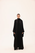 Model wearing the NOTTE luxury black silk abaya by Tre Sorelle, front view.