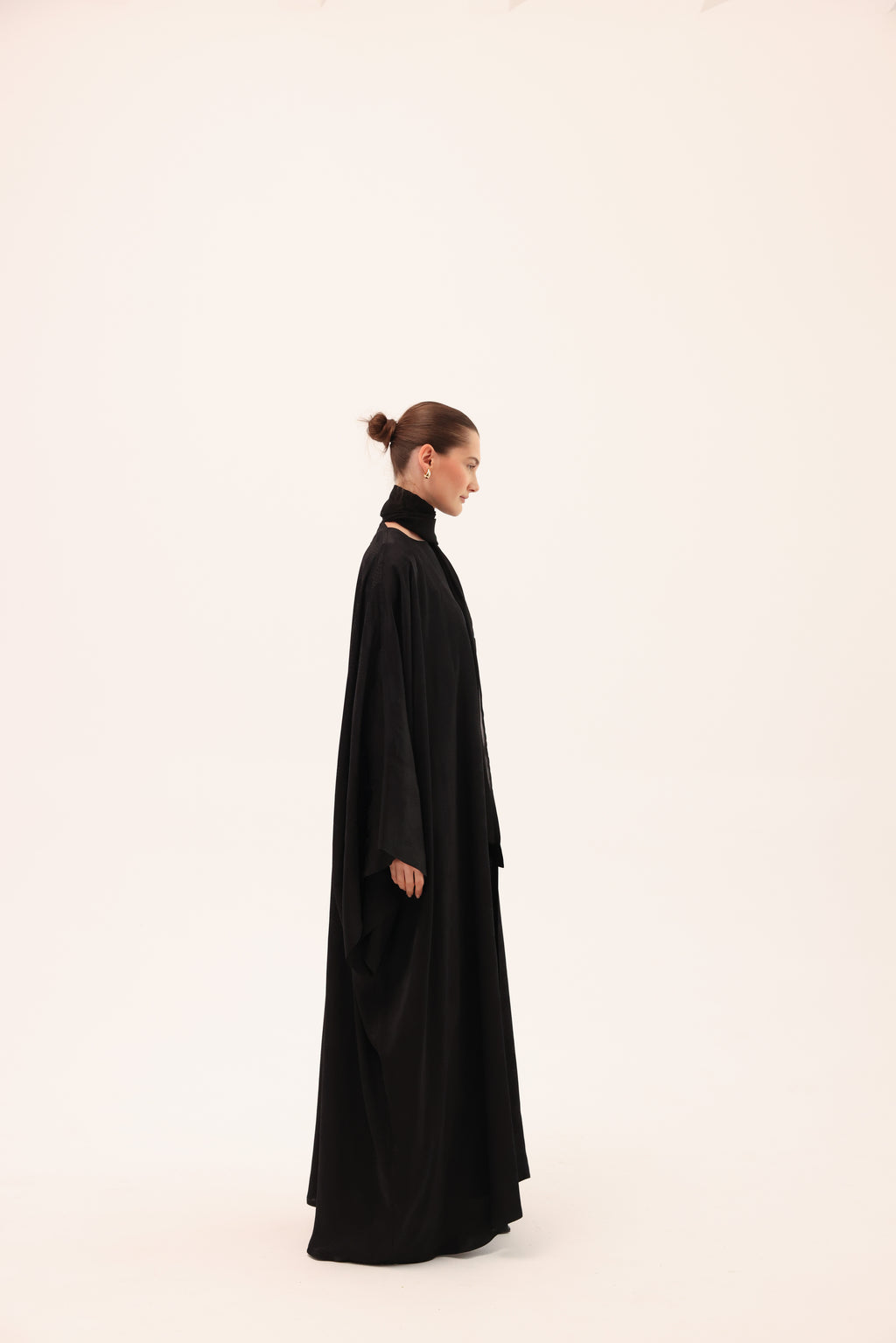 Opposite side view of the NOTTE luxury black silk abaya by Tre Sorelle.