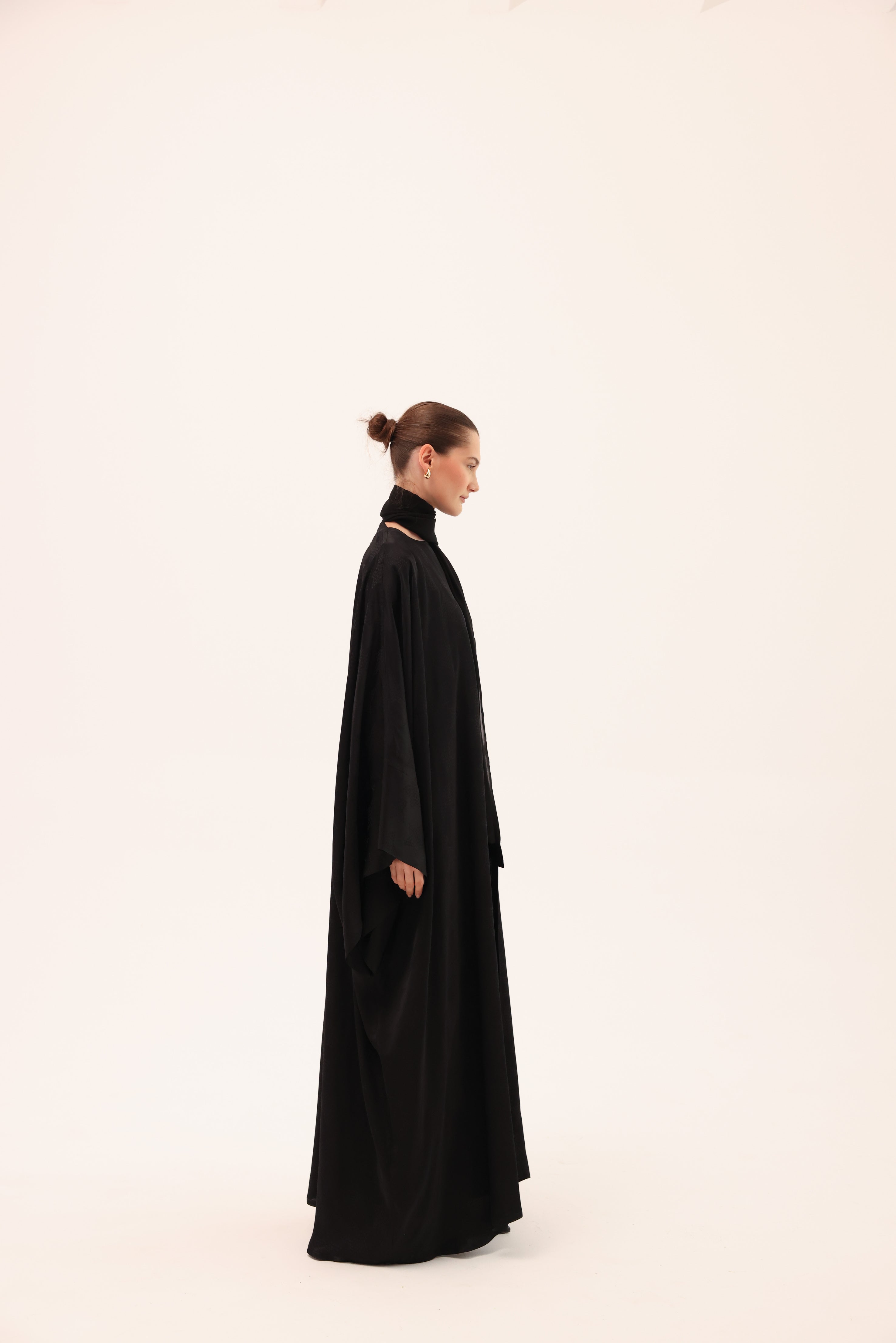 Opposite side view of the NOTTE luxury black silk abaya by Tre Sorelle.