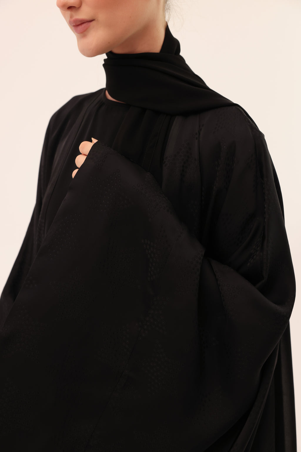 Close-up of Signature Sorelle Silk™ fabric on the NOTTE luxury black abaya by Tre Sorelle.