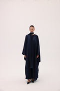 Model wearing the CIELO luxury navy blue silk abaya by Tre Sorelle, front view.
