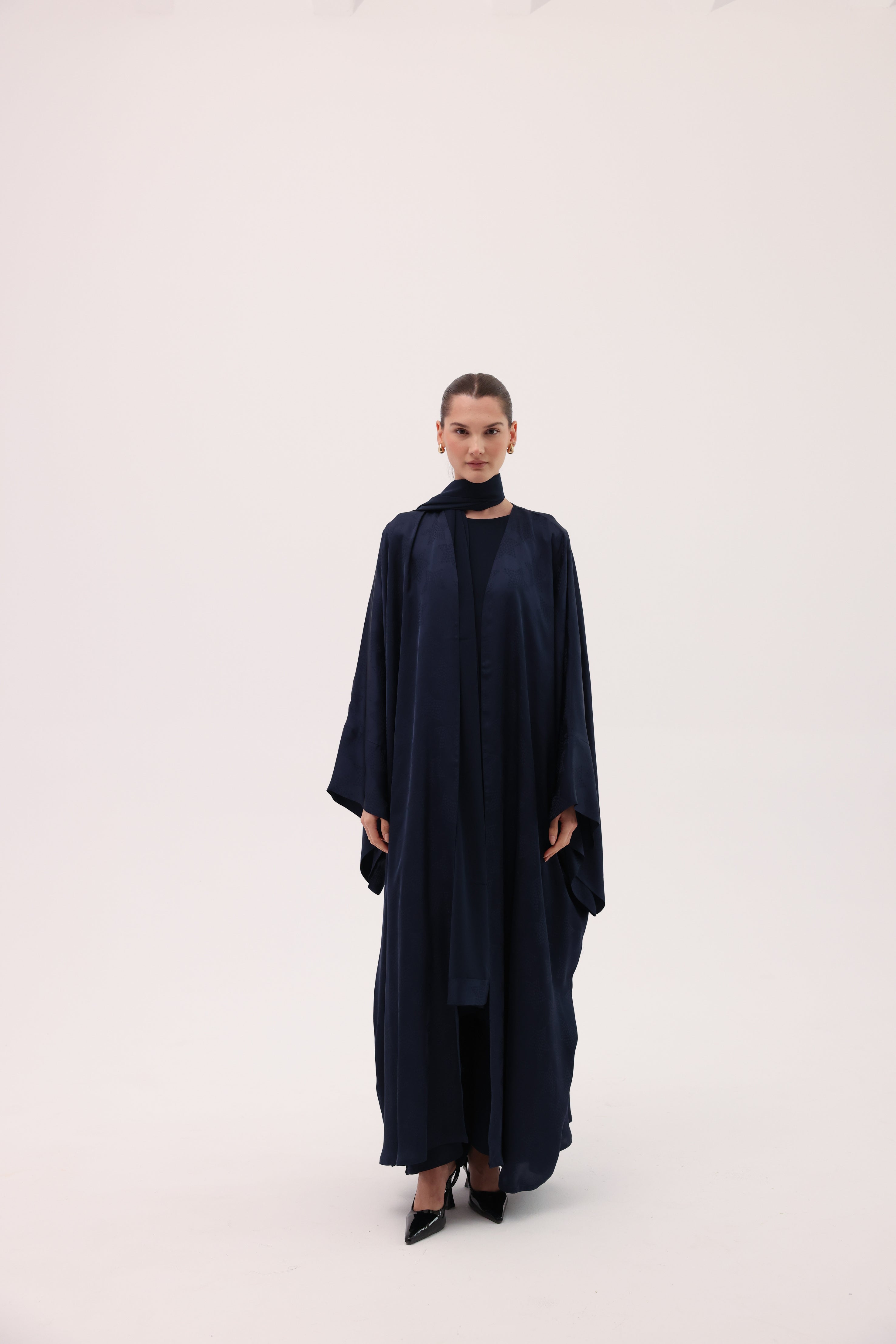 Model wearing the CIELO luxury navy blue silk abaya by Tre Sorelle, front view.