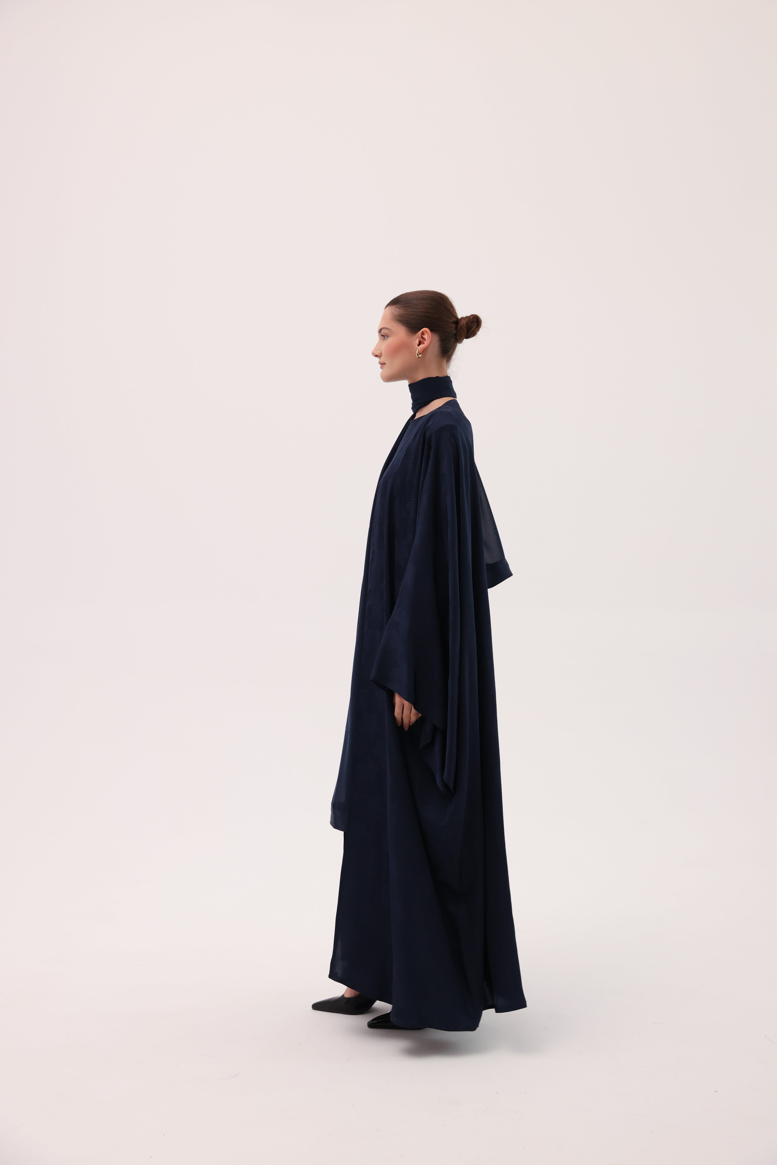Opposite side view of the CIELO luxury navy blue silk abaya by Tre Sorelle.